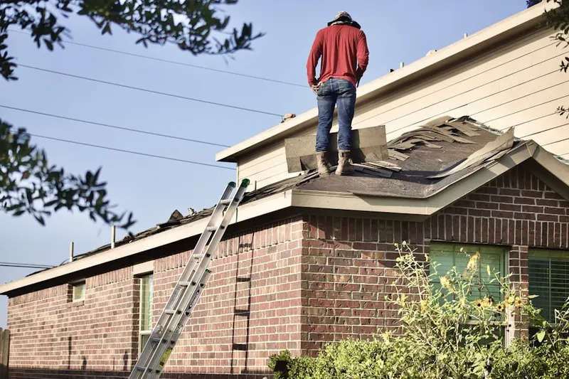 Professional roofer working on a residential roof in Skanondaga Heights